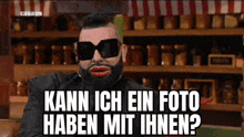 a man with a beard and sunglasses is asking if he can have a picture of himself .