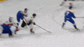 a hockey game is being played with a blurred image of a goalie