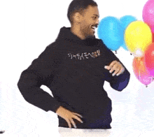 a man wearing a black hoodie with chinese writing on it
