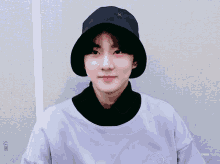 a young boy wearing a black hat and a purple shirt with check written on the bottom