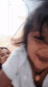 a close up of a little girl laughing with her mother .