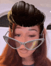a woman wearing sunglasses and a fake mohawk