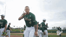 a man wearing a bullpen jersey stands on the field