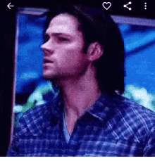 a close up of a man 's face with a heart in the corner