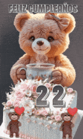 a teddy bear is holding a cup of coffee on top of a cake with the number 22 on it