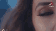 a close up of a woman 's face with a star plus logo on the bottom