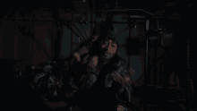 a man stands in front of a everlast machine in a dark room