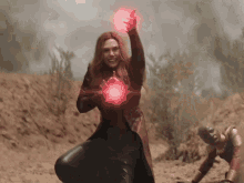 a woman in a red coat is holding a red object in her hand