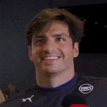 a close up of a man 's face with a smile on it .