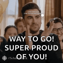 a man is applauding in front of a crowd and says way to go super proud of you