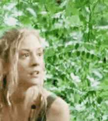 a close up of a woman 's face in front of a green background .