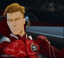 a man in a red suit with the letter b on his chest .