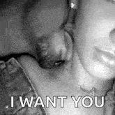 a black and white photo of a man kissing a woman 's neck and the words `` i want you '' .