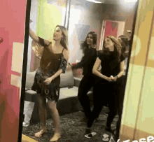 a group of women are standing in front of a mirror with the word free on the bottom