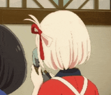 a girl with white hair and a red bow in her hair is talking on a phone