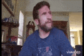 a man with a beard is wearing a blue shirt that says xtreme lightning