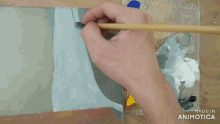 a painting of a waterfall is being painted with a brush and the words made in animotica are visible