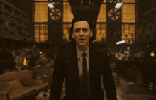 a close up of a man in a suit and tie making a face .