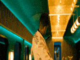 a man wearing a white jacket with a sticker on the back that says ' i love you ' on it