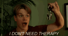 a man holding a bunch of keys with the words i don 't need therapy behind him
