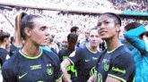 a group of female soccer players are standing in a stadium wearing jerseys that say collonil