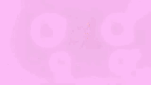 a man with glasses is sitting in front of a computer screen with pink bubbles coming out of his eyes .