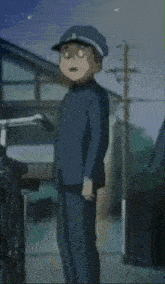 a boy in a blue uniform is standing next to a wheelchair