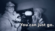 a man and a woman are standing next to each other with the words " you can just go " below them