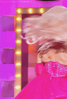 a woman in a pink dress is dancing in front of a mirror that says tumblr