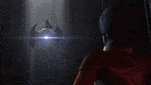 a woman stands in front of a space ship with a light shining on it