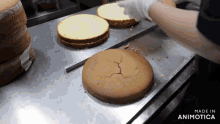 a person is cutting a cake on a table with the words made in animatica on the bottom