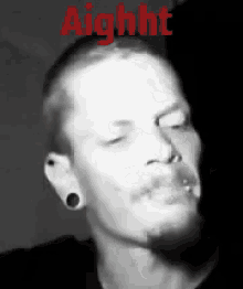 a man with a beard is smoking a cigarette in a black and white photo with the word aight above him