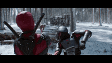 a man in a deadpool costume stands next to another man