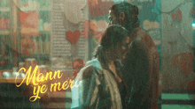 a man and a woman are standing in the rain with the words mann ye meri written on the bottom
