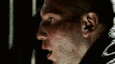a close up of a man 's face with blood on it
