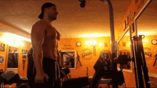 a man stands in a gym with a sign that says gum on it