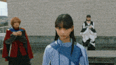 a girl wearing a blue jacket with the word samurai on the front