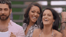 a man and two women are laughing with the hashtag #ayo on the bottom right