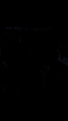 a man in a suit is clapping his hands