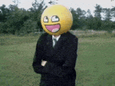 a man in a suit is wearing a smiley face on his head .