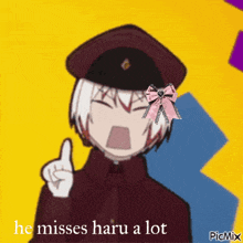 a picture of a boy with a pink bow in his hair and the caption he misses haru a lot