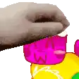 a hand is reaching for a pink object on a yellow and green object .