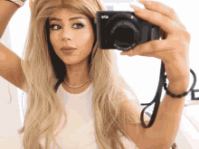 a woman is taking a picture of herself with a camera