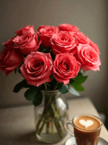 a vase of pink roses sits next to a cup of coffee with a heart on it