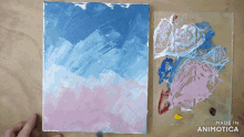 a painting is being painted on a canvas with the words made in animotica below it