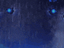 a blue background with a few lights in the middle