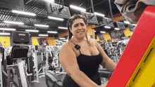 a woman is working out in a gym with a sign that says " musk "