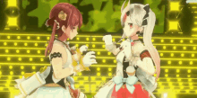two anime girls are standing next to each other in front of a stage
