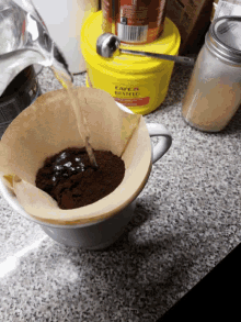 a yellow bucket that says cafe & bistro on it sits on a counter