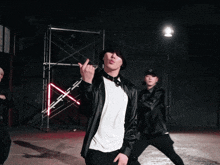 a man wearing a black hat and a white shirt is dancing